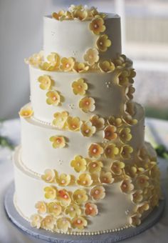 yellow sugar flowers on buttercream wedding cake.  Durham, NC