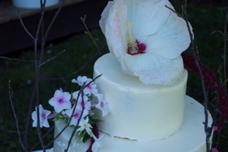 Fresh flowers on buttercream wedding cake.  Mebane, NC