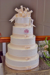 Gum paste ribbon and bow on buttercream wedding cake.
Raleigh, nc
