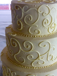 Delicate buttercream scrolls.  Elegant wedding cake,
Raleigh, NC