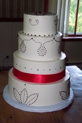 Chocolate design and red ribbon on buttercream wedding cake.
Hillsborough, NC
