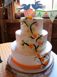 Chocolate vines, sugar flowers and leaves climbing a buttercream wedding cake.
Hillsborough, NC