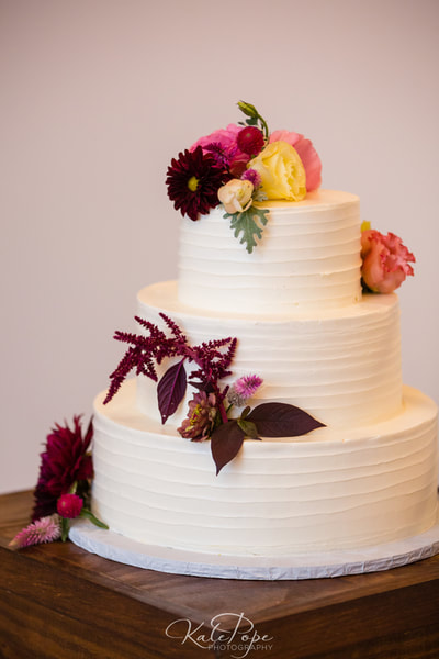 smooth horizontal lines buttercream wedding cake at the Cloth Mill in Hillsborough, NC.
Picture by Kate Pope Photography